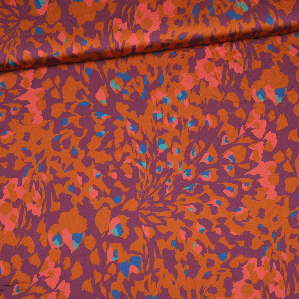 Polyester satijn paars met abstract oranje motief